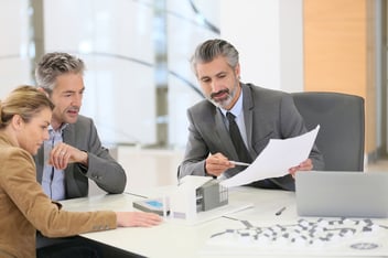 Mature couple meeting architect for construction project-1